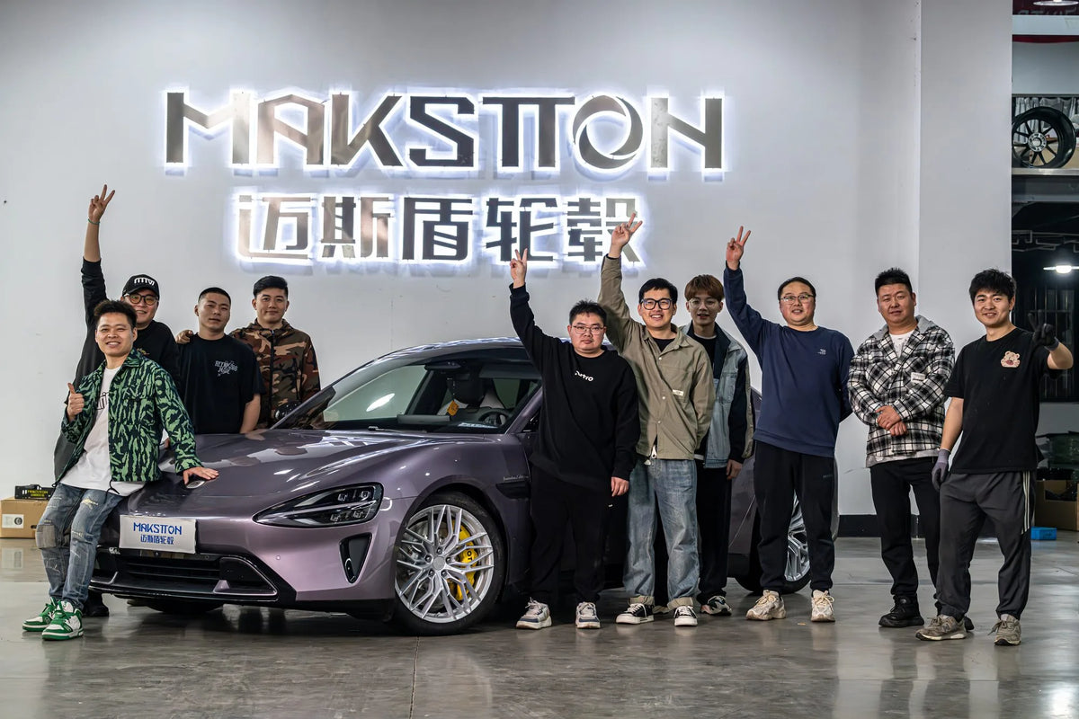 MAKSTTON team and partners beside a modified Xiaomi SU7 at the showroom — Xiaomi SU7 · First Fitment Shoot, China, 2024