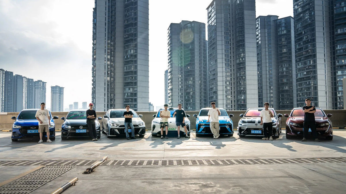 MAKSTTON owners standing beside their cars with apartment towers behind them — Guangzhou, Guangdong, China, 2025