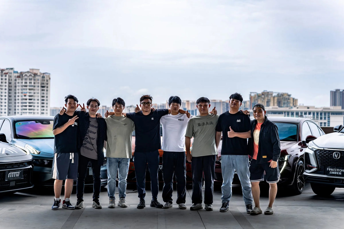 MAKSTTON owners gathered between modified cars on a rooftop parking area — Guangzhou, Guangdong, China, 2023