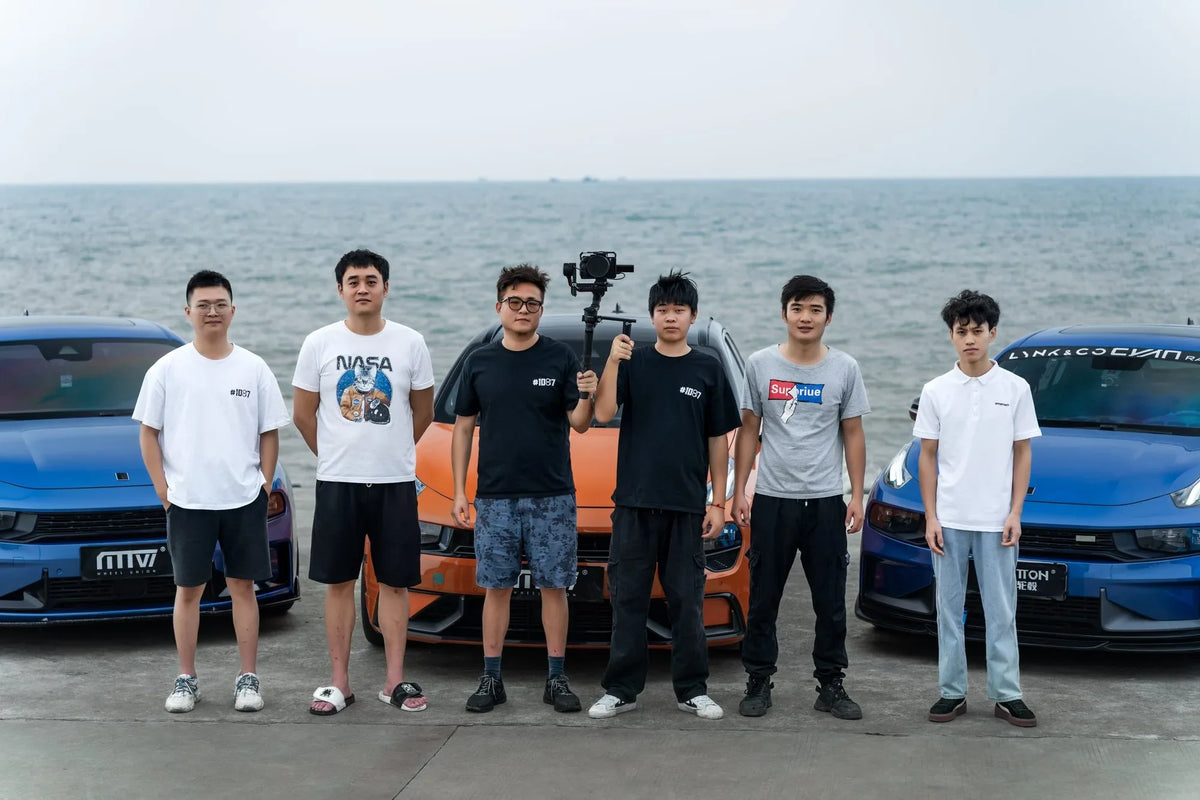 MAKSTTON owners gathered beside their cars with the sea behind them — Shantou, Guangdong, China, 2023