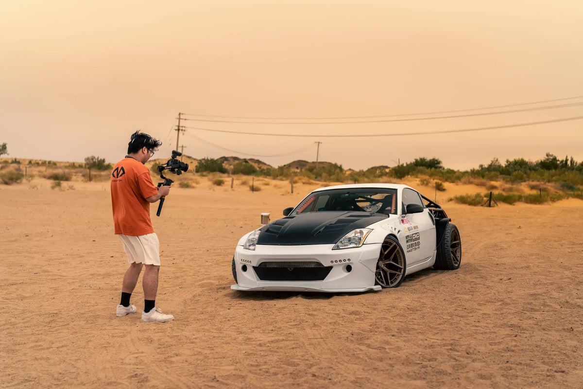 A filmmaker recording a modified white Nissan 350Z in the desert — Alxa · Jet 350Z, Inner Mongolia, China, 2026