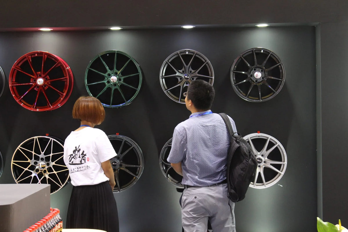 Visitors looking at red, green and silver MAKSTTON wheels — CITEXPO SHOW, Shanghai, China, 2017