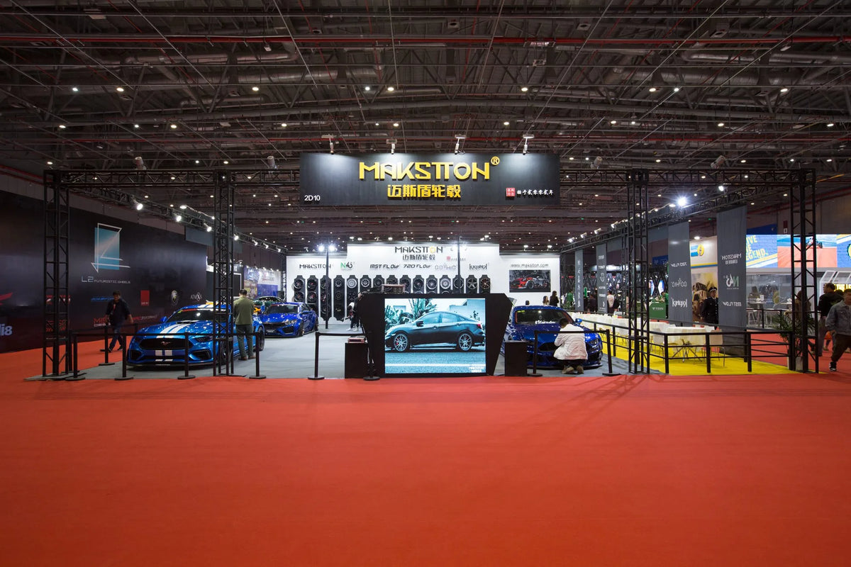 MAKSTTON exhibition stand with wheel displays and modified cars — Shanghai CAS Show, Shanghai, China, 2019